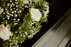 flowers on a black coffin for a funeral